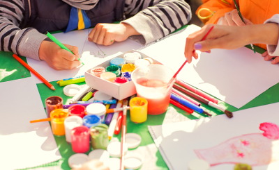 Children painting Small children's hands painting brightly coloured pictures