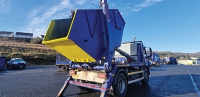 Skip on top of a bin lorry